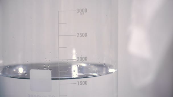 Pouring Transparent Liquid Measure Cup Close — Stock Video