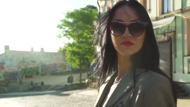 Stylische Brünette mit Sonnenbrille posiert in Zeitlupe für die Kamera — Stockvideo