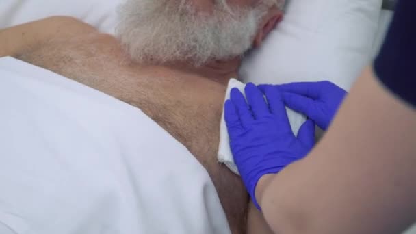 Старший мужчина на процедуре электрофореза в клинике — стоковое видео