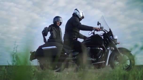 Un par de ciclistas se sientan en su motocicleta y se preparan para montar — Vídeo de stock