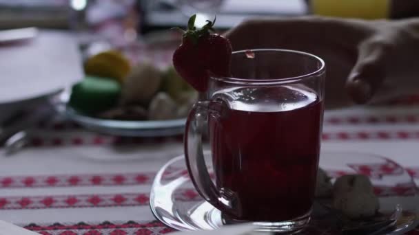 Human drinks strawberry compote in cafe — Stock Video