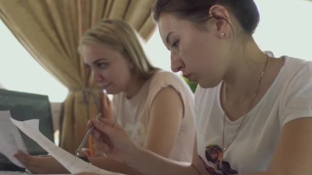 Meninas estão estudando no café — Vídeo de Stock