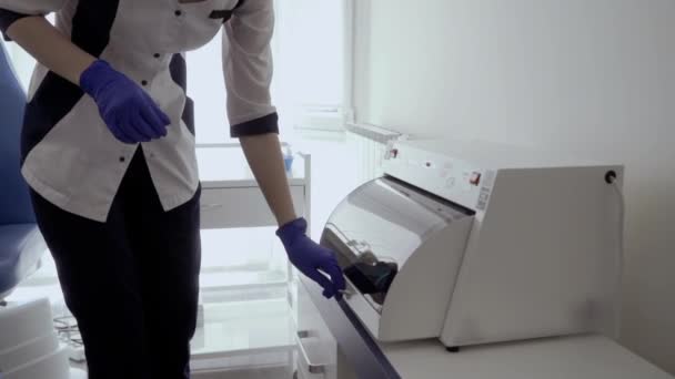 Врач в латексных перчатках открывает шкафчик с медицинскими инструментами — стоковое видео