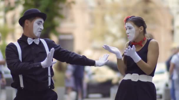 Friendly man mime give his girlfriend a jacket for warm her — Stock Video