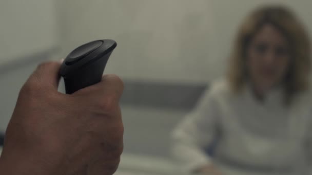 Женщина держит консоль и нажимает на кнопку — стоковое видео
