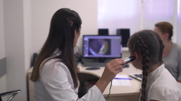 Little girl checks the hearing — Stock Video