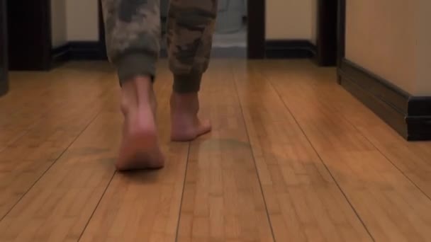 Mans legs walk from one room to another — Stock Footage Mans legs walk from one room to another Stock Footage