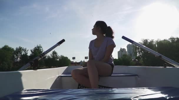 Schönes Mädchen sitzt traurig in einem Boot — Stockvideo