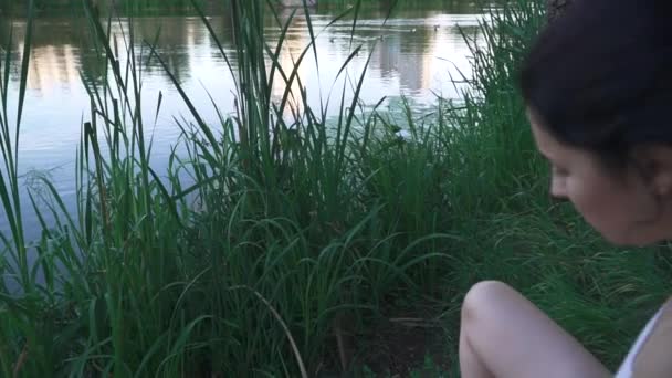 Nehir kıyısında üzerinde üzgün kız — Stok video