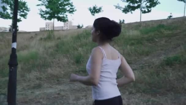 Beautiful young girl running outdoors — Stock Video