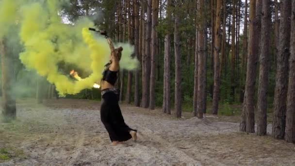 Woman is dancing with fire stick and smoke bomb — Stock Video