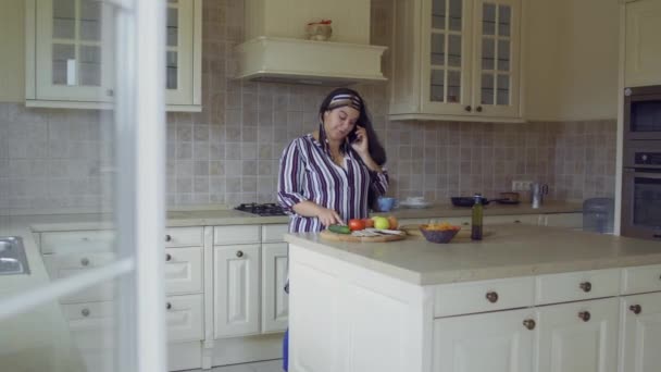 Menina gorda está cozinhando na cozinha — Vídeo de Stock