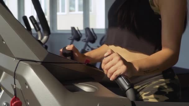 Beautiful girl on a treadmill in the gym — Stock Video