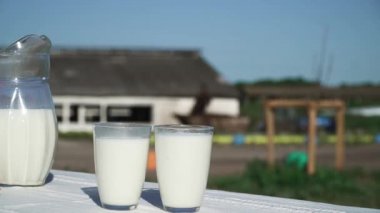 Sürahi ve iki bardak süt ile masaya vardır.