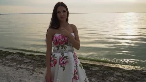 Romantische meisje in een mooie jurk aan de rivier — Stockvideo