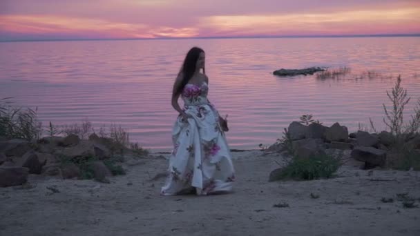 Чарівна леді в довгій сукні на красивому пляжі — стокове відео