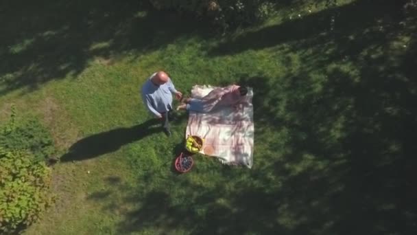 Mature couple have a rest outdoor. Shot from drone. — Stock Video