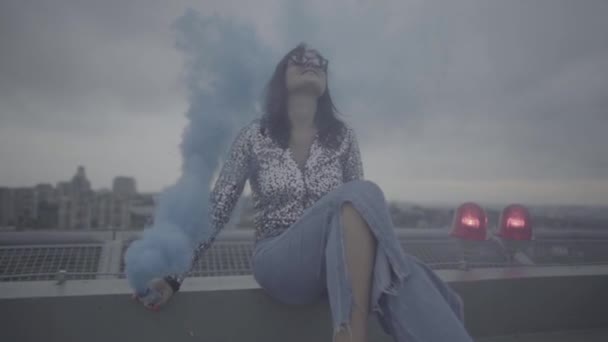 Lovely woman with smoke bomb over city background. Slow motion, s-log, ungraded — Stock Video