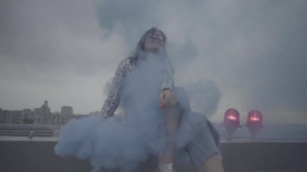 Pretty woman with smoke bomb over city background. Slow motion, s-log, ungraded — Stock Video