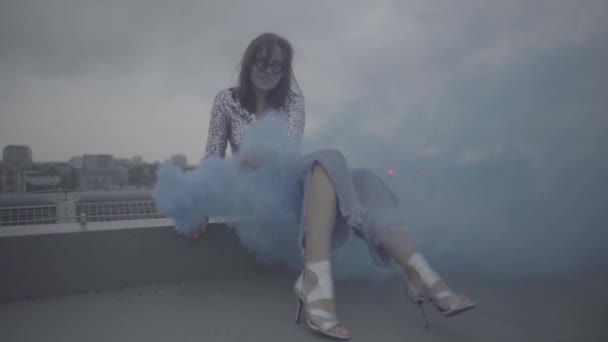 Cute woman with smoke bomb over city background. Slow motion, s-log, ungraded — Stock Video