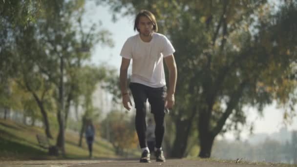 Чоловічий бігун бере низький старт в парку — стокове відео