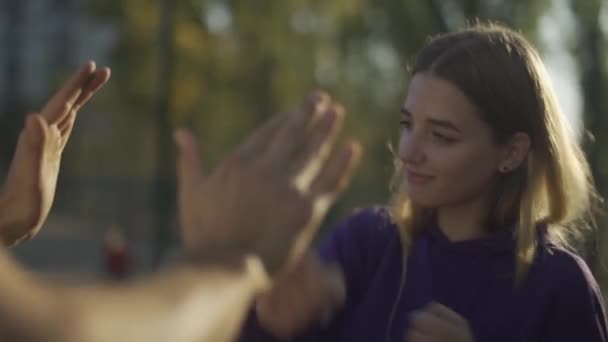 Masculino ensina bonito menina para caixa ao ar livre — Vídeo de Stock