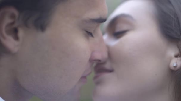 Masculino e feminino beijos ao ar livre cara com namorada passar tempo juntos casal no amor feliz casal close-up de um jovem casal beijo — Vídeo de Stock