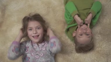 Tatlı küçük çocuklar ile tüylü halı yerde yatarken pijama.