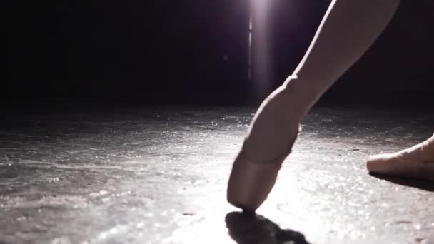 Close up of female leg in pointe and hands isolated on black background. — Stock Video