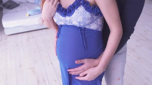 Gravid kvinna och hennes make stå nära varandra. Mamma och pappa händer på gravida mage. Moderskap koncept. Graviditet. Lycklig familj. — Stockvideo