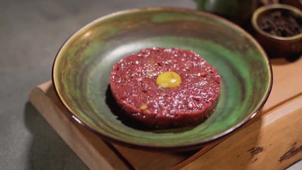 Tartar preparation in restaurant kitchen close up. Minced meat with yolk are on the plate — Stock Video