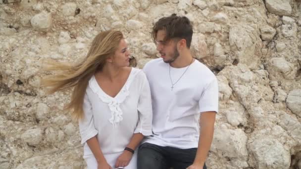 Young beautiful couple stand near big rocks and talking — Stock Video