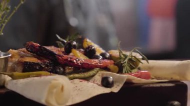 Izgara Somon Balık Soslar, otlar, zeytin, biber, limon ve pide üzerinde yalan limon ile servis closeup kapatın. Hazırlama ve bir restoranda yemek servisi