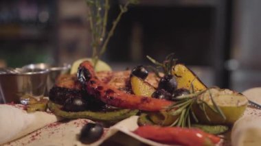 Izgara Somon Balık servis otlar, zeytin, biber ve limon pide üzerinde yalan yakın çekim. Hazırlama ve bir restoranda yemek servisi. Kamera yukarı taşır