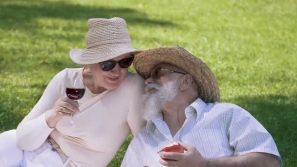 Portrait of handsome senior man give an apple to his lovely wife — Stock Video