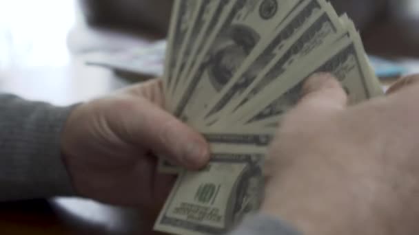 Hands of the old man counting dollars close up. Positive rich man demonstrates his money. Leisure of prosperous retired man. Great business deal — Stock Video