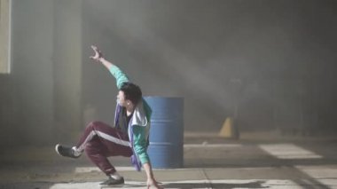 Sisin içinde terk edilmiş bir binada, varil yakınındaki hip-hop genç dansçı deneyimli. Hip hop kültürü. Prova. Çağdaş.