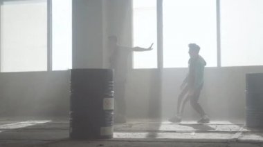 Varil yakın terk edilmiş bir binada iki sokak dansçıları dans savaşı. Hip hop kültürü. Prova.