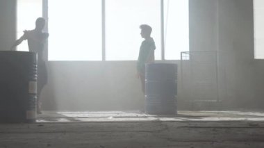 Varil yakın terk edilmiş bir binada iki sokak dansçıları dans savaşı. Hip hop kültürü. Prova.