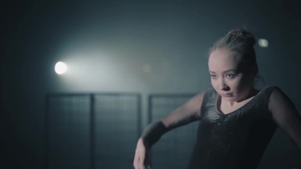Porträtt av professionell ballerina dansa i svart klänning i studion i strålkastarljuset på svart bakgrund. Unga vackra balett dansare övergripande kropp tillbaka och kastar mjöl. Slow motion. — Stockvideo