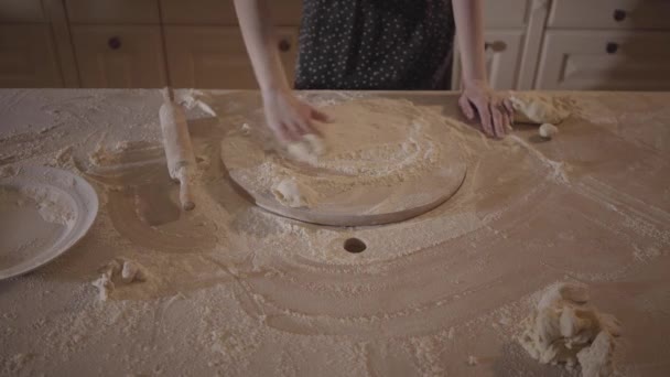Femme méconnue dans la table de cuisine dessiner soleil sur la planche à pâtisserie avec de la farine, rouleau à pâtisserie sur la table . — Video