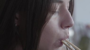 Yakın yukarı, Chopsticks kullanarak erişte yiyen genç kadının yüzünü yakın. Çin restoranında akşam yemeği. Lezzetli iştah açıcı sağlıklı gıda