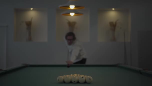 Handsome blond bearded man playing pool, billiards in light room. Confident player hits the ball with a cue. American pool billiard. Pool billiard game. Billiard sport concept — Stock Video