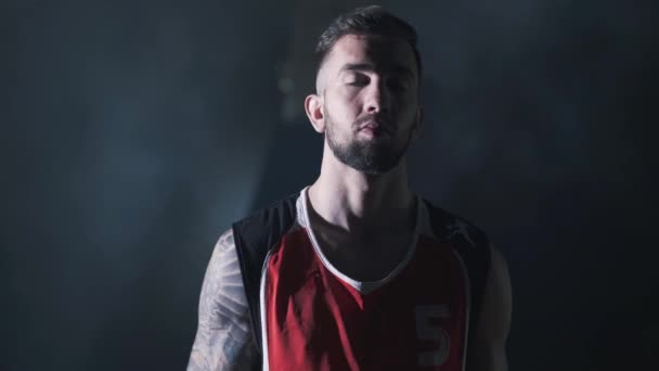 Portrait of handsome confident basketball player who play with ball in strong hands with tattoo — Stock Video