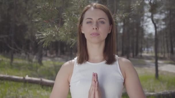 Portrait graceful cute woman with praying hands is pray in the amazing spectacular green forest — Stock Video