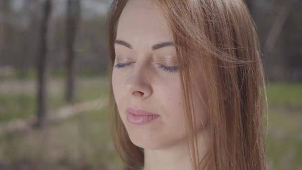 Gros plan portrait de gracieuse jeune femme mignonne aux cheveux bruns dans la forêt — Video