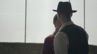 Fedora şapkalı adam, klasik takım elbise li ve kirli yerde dans tarzı kumaş kadın. Terk edilmiş harap bina. Kendine güvenen işadamı rahatlatıcı.