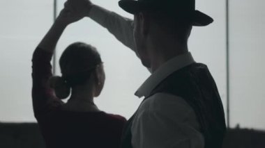 Fedora şapkalı portre erkeği, klasik takım elbise li ve kirli yerde dans tarzı kumaş kadın.