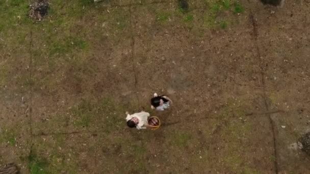 View from above of two charming young women wear summer dresses standing in the top of rock and looking at amazing view of nature. Adorable girlfriends spending weekend together outdoors. Shooting — Stock Video