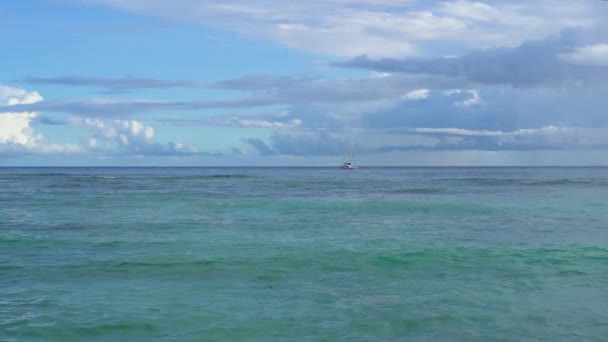 Seyşeller. Praslin Adası. Berrak mavi su ve gökyüzü ile inanılmaz deniz manzarası. Okyanusa uzak yalnız Yelkenli. Yağmurlu bulutlar okyanus yüzeyine asacak. Turizm, seyahat konsepti. Yavaş hareket. — Stok video